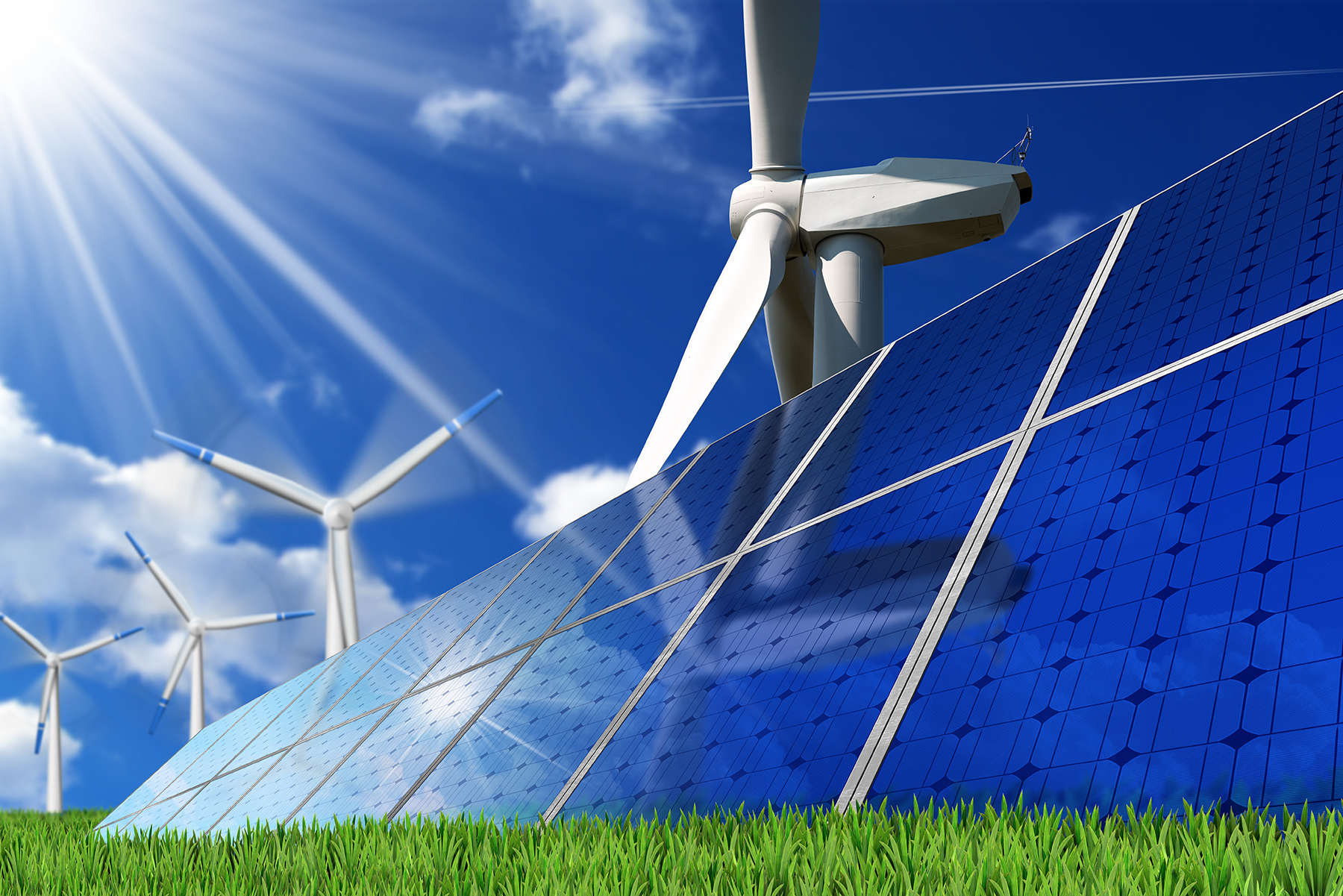 Group of solar panels and wind turbines on a blue sky with clouds and sun rays. Solar and wind energy